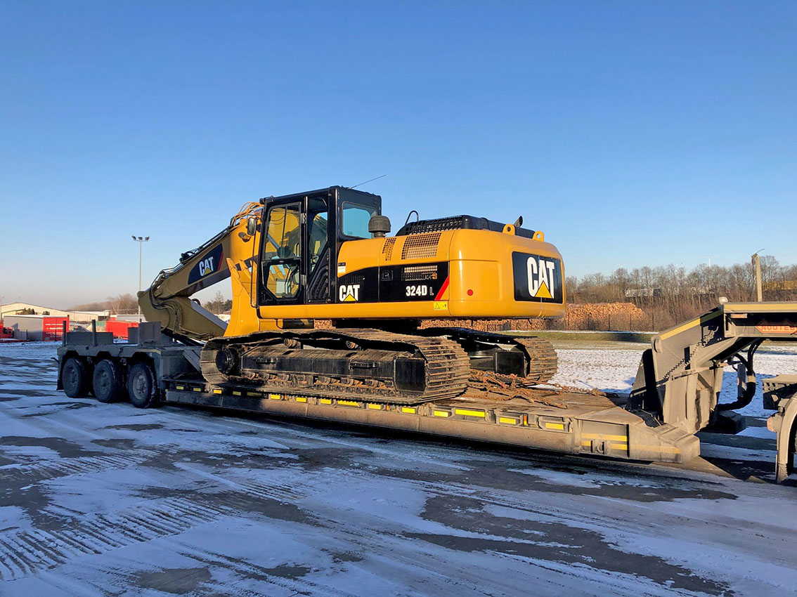 Caterpillar 324D L excavator loaded on a low-loader trailer